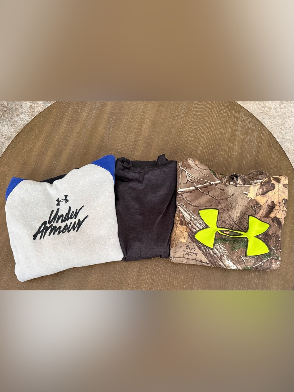 2 Under Armor sweatshirts and 1 Reebok